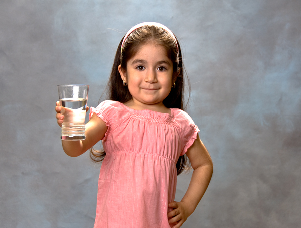 Young Girl Holding a Glass of Water